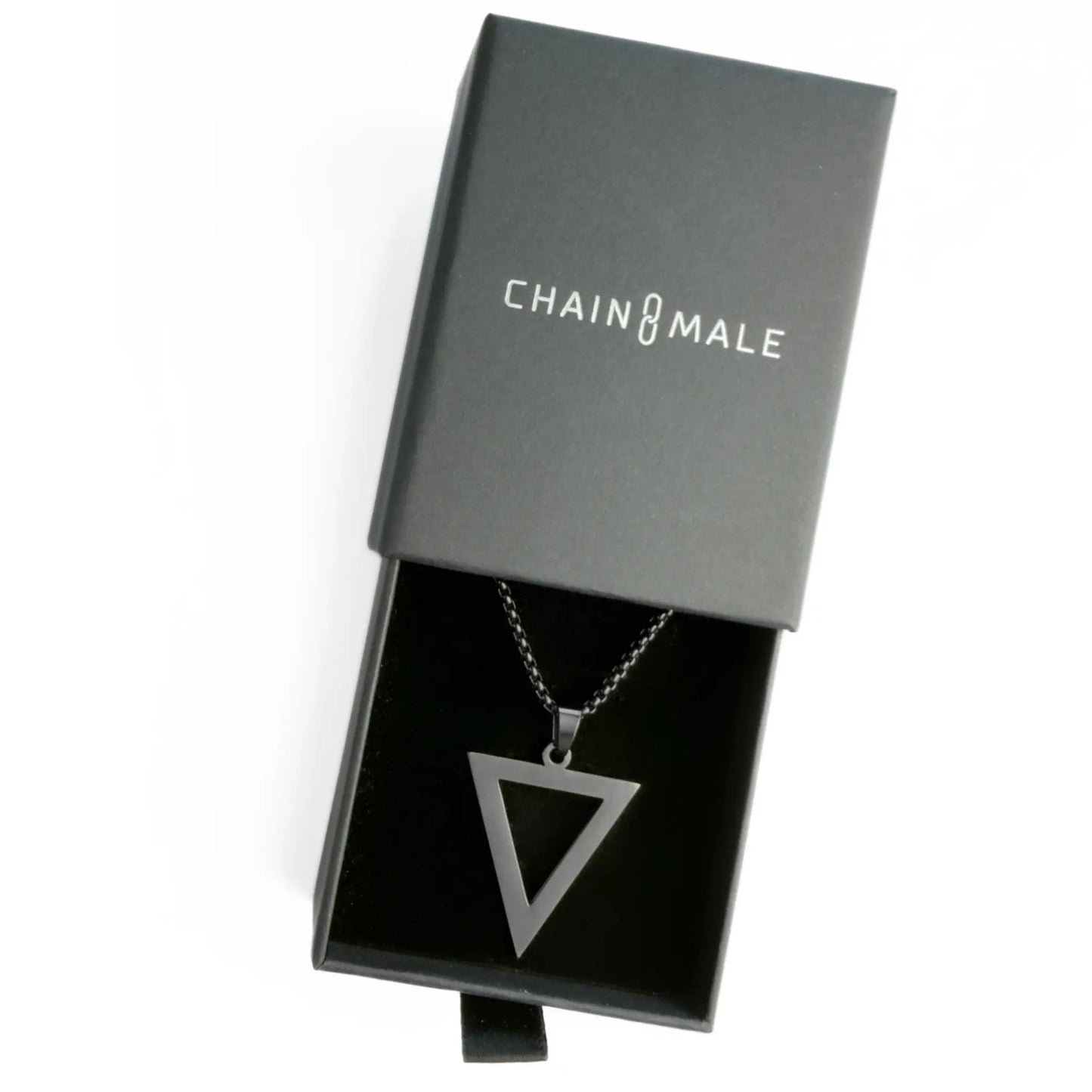Black pendant necklace in a black Chain Male jewellery box on a white background