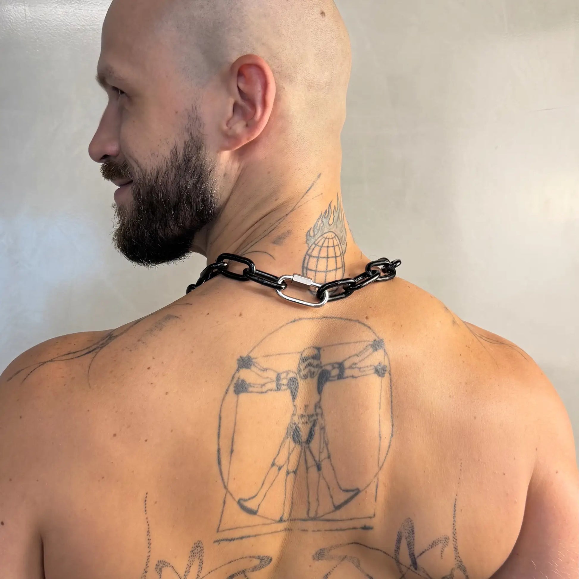Big Black Chain necklace worn by a tattooed man showing the clasp detail from behind
