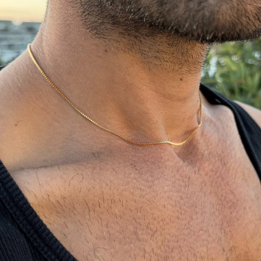 Chain Male gold 1.2mm box chain necklace close-up, ultra slim 18ct gold plated men's everyday jewellery