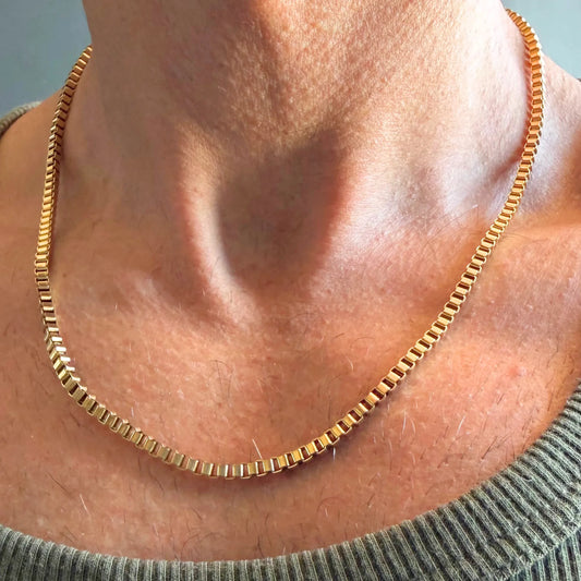 Chain Male gold 3mm box chain necklace close-up worn with singlet, 18ct gold plated square link men's jewellery