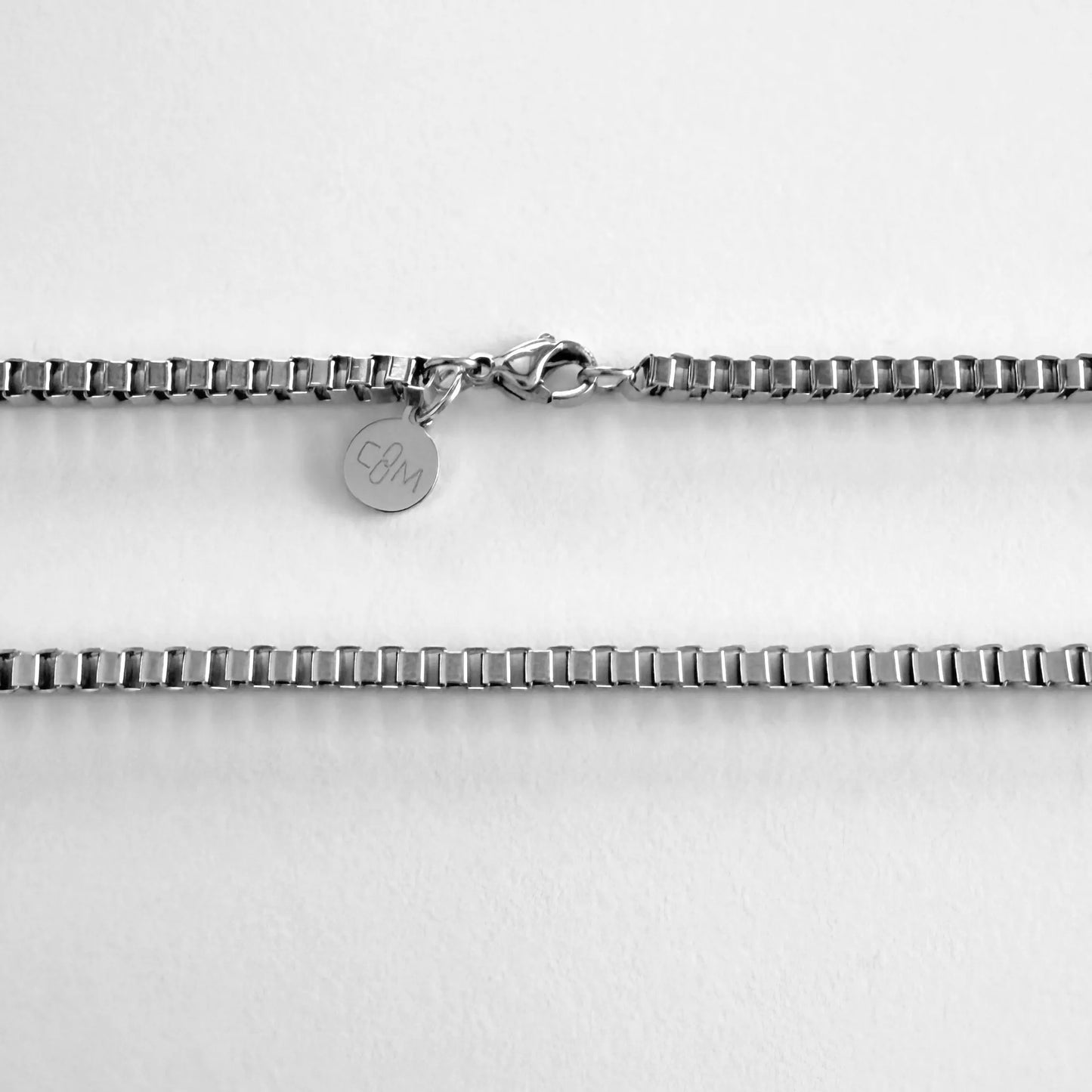 Chain Male silver 3mm box chain necklace flat lay with CM charm, stainless steel men's Everyday collection