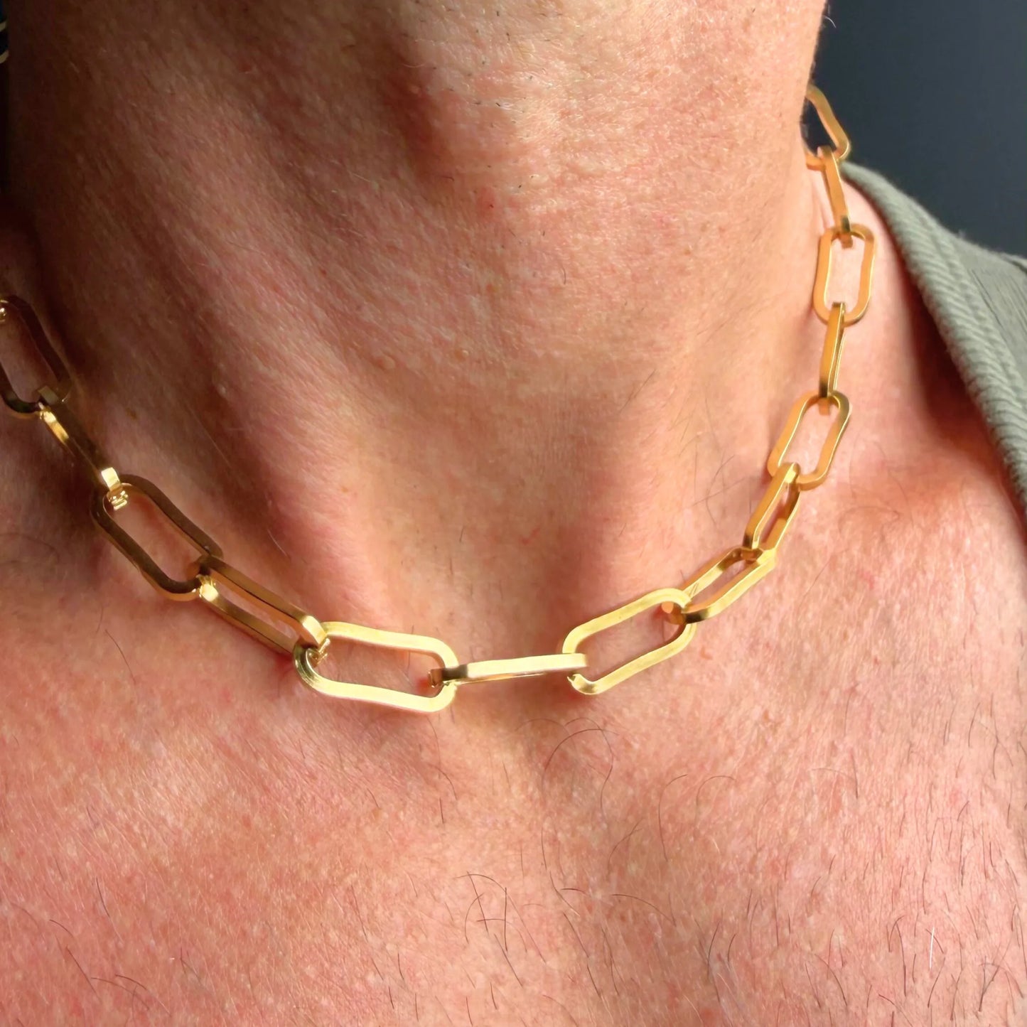 Chain Male gold paperclip choker necklace close-up, oversized rectangular link 18ct gold plated men's jewellery