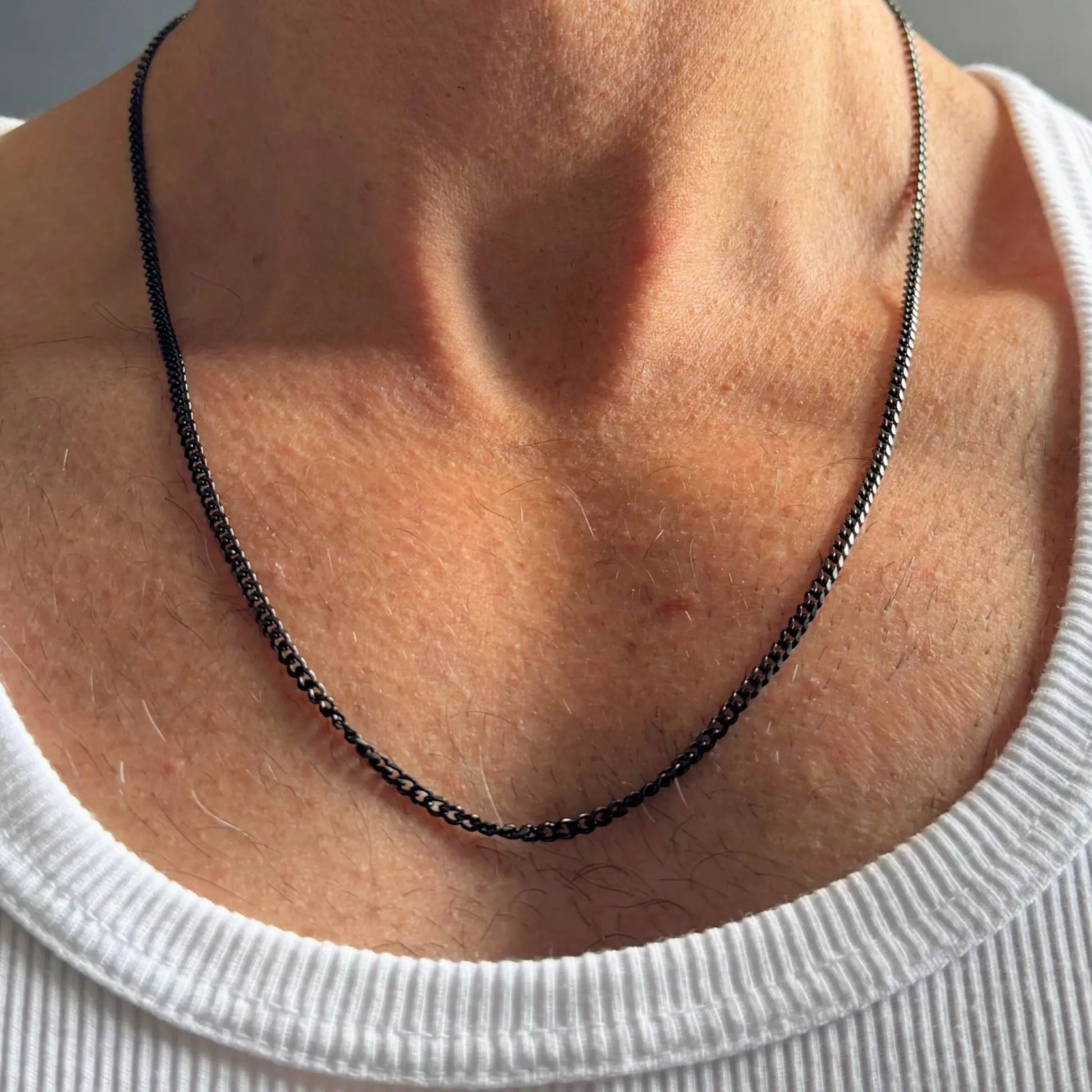 Chain Male black 3mm curb chain necklace close-up, black plated stainless steel everyday men's jewellery
