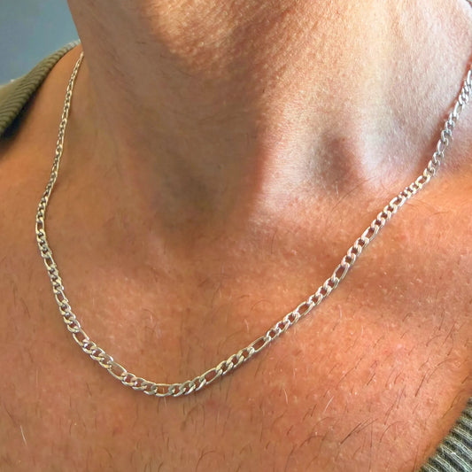 Chain Male silver 3mm Figaro chain necklace close-up worn with singlet, slim stainless steel alternating link men's jewellery