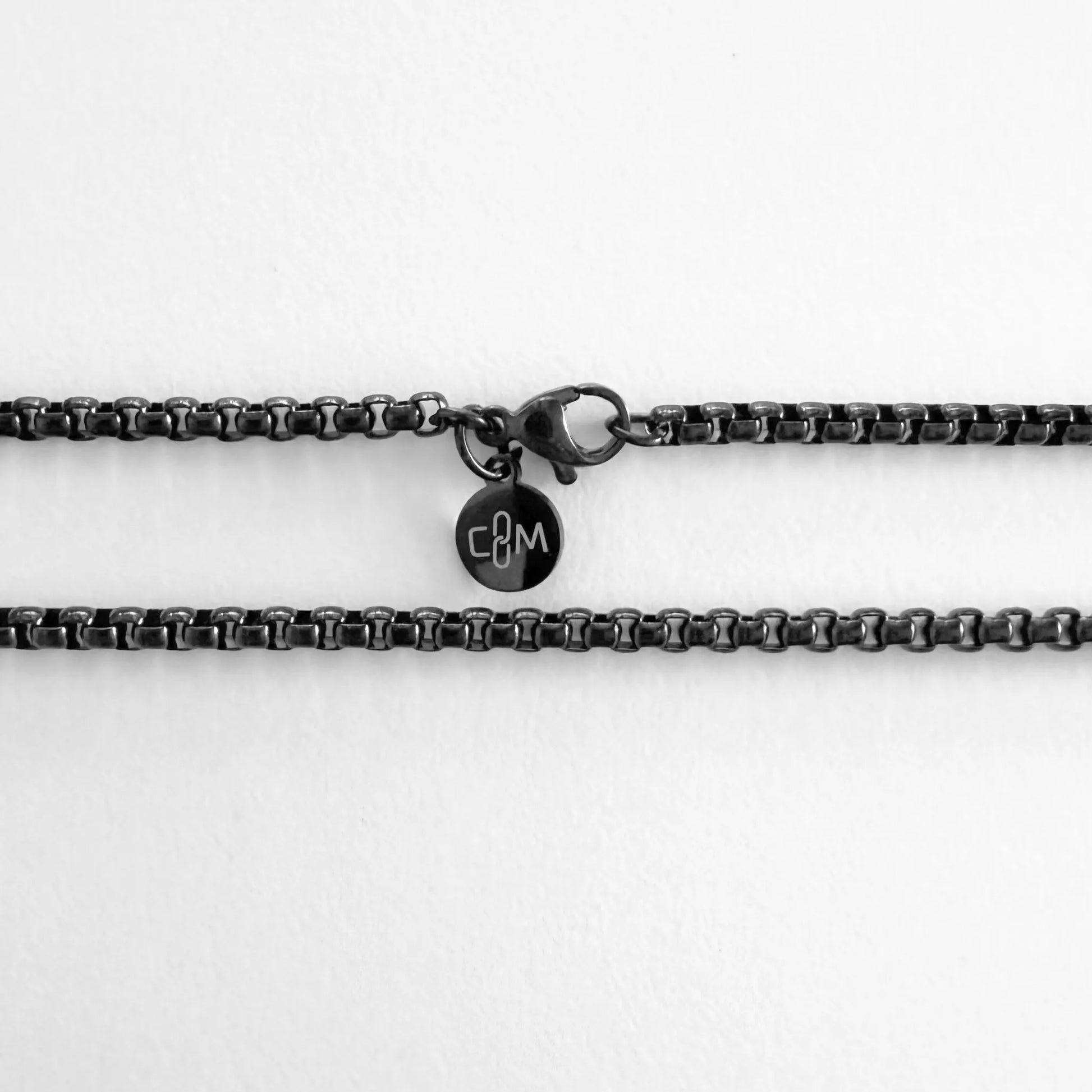 Chain Male black rolo chain necklace flat lay with CM charm, black plated stainless steel men's Everyday collection