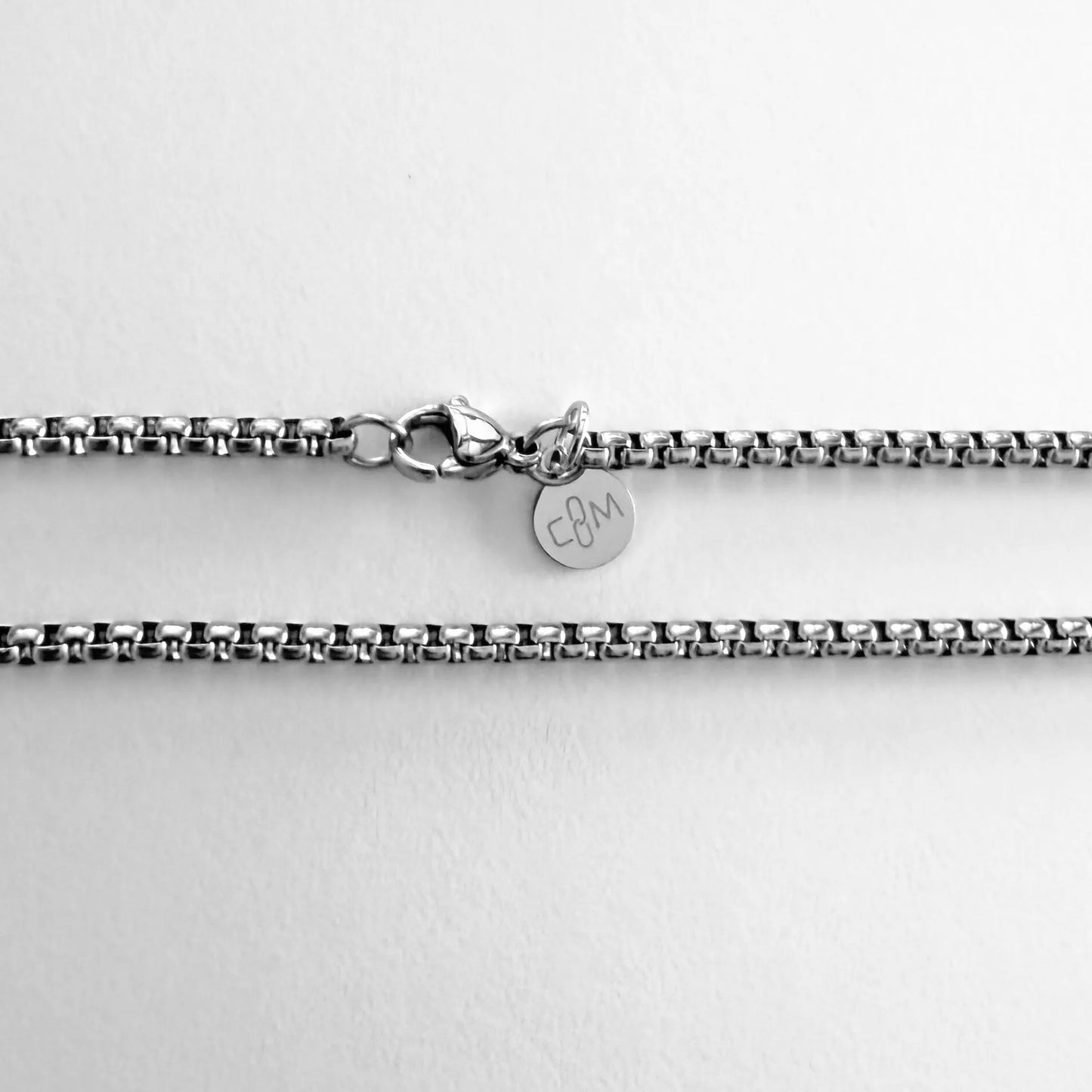 Chain Male silver rolo chain necklace flat lay with CM charm, 3mm stainless steel men's Everyday collection