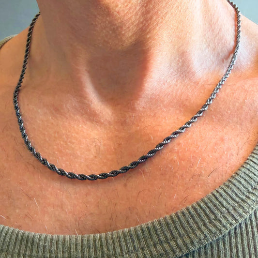 Chain Male black rope chain necklace close-up worn with singlet, black plated twisted stainless steel men's jewellery