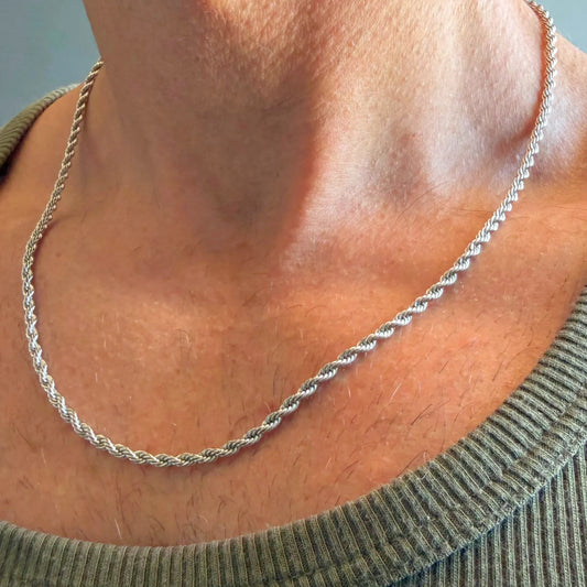 Chain Male silver rope chain necklace close-up worn with singlet, twisted stainless steel men's jewellery
