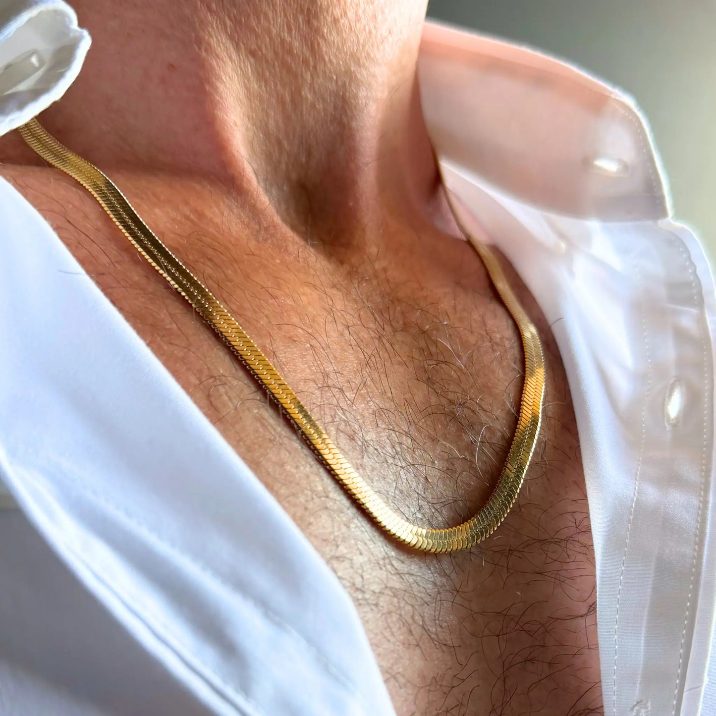 Chain Male gold 5mm snake chain necklace close-up worn with open shirt, 18ct gold plated stainless steel men's jewellery